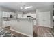 Bright kitchen with white cabinets, modern appliances, and breakfast bar with stylish pendant lighting at 129 Woodbridge Cir, Mount Holly, NC 28120