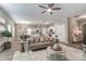 Spacious living room with open floor plan, hardwood floors, modern decor, and a ceiling fan at 129 Woodbridge Cir, Mount Holly, NC 28120