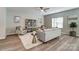 Bright living room with modern furniture, plush rug, ceiling fan, and stylish decor creating a cozy ambiance at 129 Woodbridge Cir, Mount Holly, NC 28120