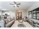 Open-concept living room with modern decor, hardwood floors, ceiling fan, and seamless flow to other rooms at 129 Woodbridge Cir, Mount Holly, NC 28120