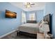 Cozy bedroom with a ceiling fan, grey carpet, and a large window at 14507 Old Vermillion Dr, Huntersville, NC 28078