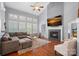 Spacious living room features a fireplace, large windows with plantation shutters, and hardwood floors at 14507 Old Vermillion Dr, Huntersville, NC 28078