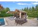 Outdoor living space features a covered kitchen, outdoor TV, lounge seating, and an in-ground pool at 14507 Old Vermillion Dr, Huntersville, NC 28078