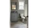 Bathroom with granite vanity, gray cabinets, and tile floor at 1526 W Horah St, Salisbury, NC 28144