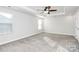 Spacious bedroom featuring neutral decor, a ceiling fan, and natural light at 1686 Scarbrough Sw Cir, Concord, NC 28025