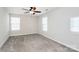 Empty bedroom with neutral carpet, recessed lights, and bright, natural light from large windows at 1686 Scarbrough Sw Cir, Concord, NC 28025