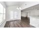Bright dining area with French doors, bar top and wood-look flooring at 1686 Scarbrough Sw Cir, Concord, NC 28025