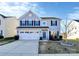 Charming two-story home with a well-manicured lawn and a two-car garage at 1686 Scarbrough Sw Cir, Concord, NC 28025