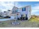 A beautifully landscaped front yard with a young tree enhances the curb appeal at 1686 Scarbrough Sw Cir, Concord, NC 28025