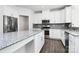 Modern kitchen with stainless steel appliances, granite counters and white cabinetry at 1686 Scarbrough Sw Cir, Concord, NC 28025