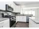 Modern kitchen with stainless steel appliances and gray subway tile backsplash at 1686 Scarbrough Sw Cir, Concord, NC 28025