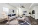 Elegant living room featuring modern decor, hardwood floors, and a ceiling fan at 1686 Scarbrough Sw Cir, Concord, NC 28025