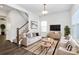 Bright living room features stylish decor, hardwood floors and staircase to the second level at 1686 Scarbrough Sw Cir, Concord, NC 28025