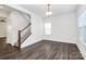 Bright living room with stylish hardwood floors and staircase to the second level at 1686 Scarbrough Sw Cir, Concord, NC 28025