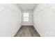Spacious walk-in closet with white wire shelving for optimal storage and organization at 1686 Scarbrough Sw Cir, Concord, NC 28025