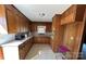 Functional kitchen with wood cabinets, plenty of counter space, and linoleum floors at 1735 Hollandale Dr, Gastonia, NC 28054