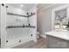 Stylish bathroom features a glass-enclosed shower with gray and white tile and modern fixtures at 202 Deitz Rd, Statesville, NC 28625