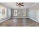 Spacious bedroom featuring wood-look floors, two bright windows, and a ceiling fan at 202 Deitz Rd, Statesville, NC 28625