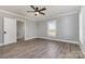 Bedroom with wood-look floors, ceiling fan, and a view of the front yard at 202 Deitz Rd, Statesville, NC 28625