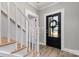 Inviting entryway featuring a modern black door with a wreath, complemented by light gray walls and wood-look flooring at 202 Deitz Rd, Statesville, NC 28625
