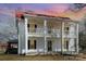 A charming home with a red roof and double porches features black shutters and a wreath on the front door at 202 Deitz Rd, Statesville, NC 28625