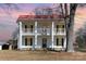 Charming two-story home with a red roof, double porches, black shutters, and a wreath on the front door at 202 Deitz Rd, Statesville, NC 28625