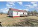 Side view of the exterior of the house with a metal roof and a small deck at 202 Deitz Rd, Statesville, NC 28625