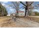 A charming home with a red roof and a double porch nestled among mature trees on a spacious lot at 202 Deitz Rd, Statesville, NC 28625