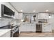 Stylish kitchen featuring white cabinets, stainless steel appliances, and a subway tile backsplash at 202 Deitz Rd, Statesville, NC 28625