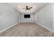 Bright, open living room featuring light gray walls, modern flooring, and a ceiling fan for comfort at 202 Deitz Rd, Statesville, NC 28625