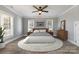 Cozy main bedroom with a bed placed on a round woven rug and light-filled windows at 202 Deitz Rd, Statesville, NC 28625