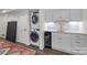 Contemporary laundry area with stacked washer/dryer, marble countertop, and beverage fridge at 2128 Greenway Ave, Charlotte, NC 28204