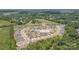 Drone shot showcasing the layout of the neighborhood with houses nestled among mature trees and green spaces at 215 Pintail Dr, Monroe, NC 28110