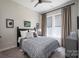 Cozy bedroom featuring a full-size bed with luxury linens, natural light, and modern decor at 215 Pintail Dr, Monroe, NC 28110