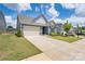 Inviting single Gathering home with a spacious driveway, well-maintained lawn, and attractive curb appeal at 215 Pintail Dr, Monroe, NC 28110