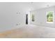 Bright bedroom with two windows offering natural light and a dark colored door at 2230 Revolution Park Dr, Charlotte, NC 28208