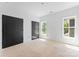 Bedroom showcasing double doors and windows overlooking the outdoors at 2230 Revolution Park Dr, Charlotte, NC 28208