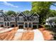 Gray duplex with garages, white trim, and well-lit front entrances at 2230 Revolution Park Dr, Charlotte, NC 28208