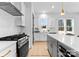 Modern kitchen featuring stainless steel appliances, a central island, and sleek white cabinets at 2230 Revolution Park Dr, Charlotte, NC 28208