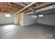 Spacious unfinished basement with a built-in storage room, ready for customization at 233 Third Creek Rd, Statesville, NC 28677