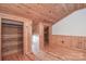 This bedroom features wood paneling, hardwood floors, and ample closet space at 233 Third Creek Rd, Statesville, NC 28677