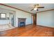 Open-concept living room featuring hardwood floors and a fireplace at 233 Third Creek Rd, Statesville, NC 28677