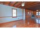 Spacious living room features wood beams, a stone fireplace, and hardwood flooring at 233 Third Creek Rd, Statesville, NC 28677