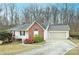 Brick ranch home with attached garage and landscaped yard at 234 Candle Nw Ct, Concord, NC 28027