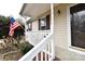 Tan house exterior with white porch railing, and American flag at 234 Candle Nw Ct, Concord, NC 28027