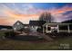 Lush backyard featuring a patio, gazebo, and a fire pit, ideal for relaxation and outdoor gatherings at 2370 Old Mountain Rd, Statesville, NC 28625