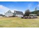 Large backyard view of the house, deck, gazebo, fire pit, and mature landscaping at 2370 Old Mountain Rd, Statesville, NC 28625