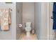 Half-bath features tile floors, a standard toilet, and a towel rack at 2370 Old Mountain Rd, Statesville, NC 28625