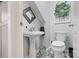 Stylish powder room featuring a pedestal sink, updated fixtures, and decorative floor tiles at 2370 Old Mountain Rd, Statesville, NC 28625