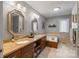 Spacious bathroom featuring double sinks, granite countertops, jacuzzi tub, and updated fixtures at 2370 Old Mountain Rd, Statesville, NC 28625